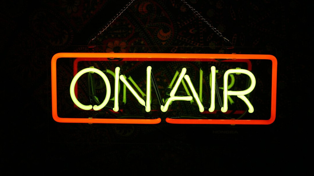 Illuminated on air sign above a television studio door